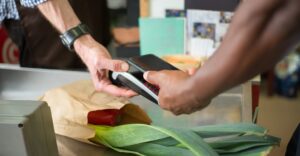 Transaction at grocery store checkout with trusted employee and background checks for retail.jpg