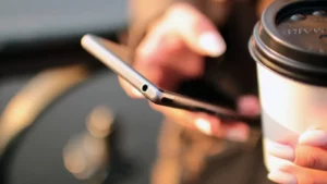 Woman using SMS invite to complete background check on her smartphone