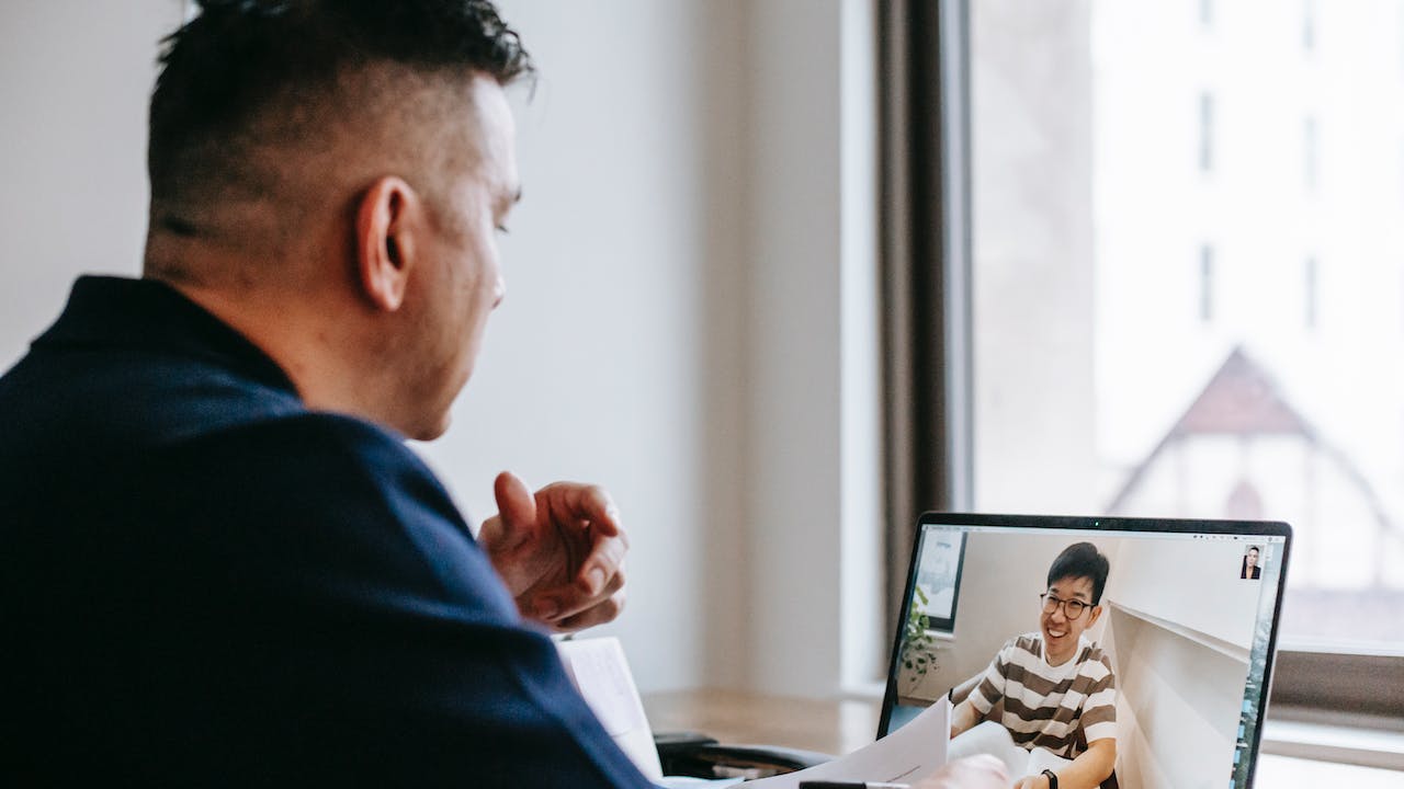 Remote employee having online meeting depecting the future of work needs a better background check process