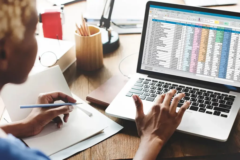 woman on computer using spreadsheets showcasing how spreadsheets are holding small businesses back
