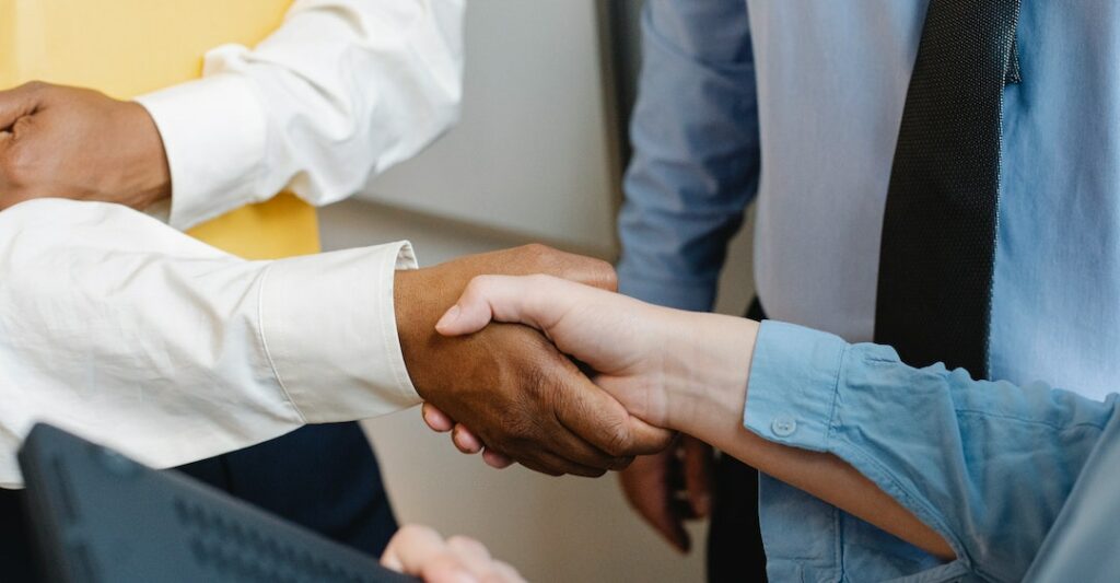 Shaking hands and agreeing with colleagues on how to create a background screening policy