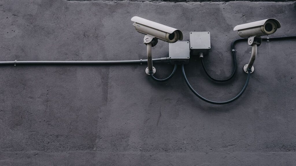 Security guard CCTV camera to keep building safe alongside background checks for security guards