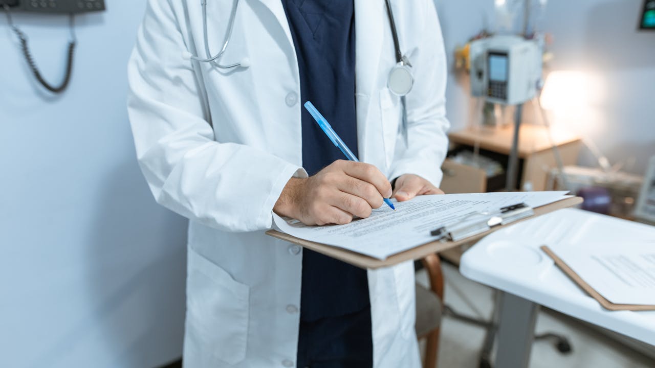 Doctor reviewing patient chart authorized to work with background checks for healthcare workers