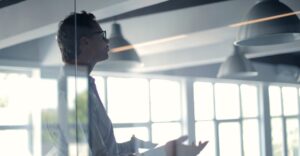 Man asking question to audience in workplace representing 10 background check terms you need to know