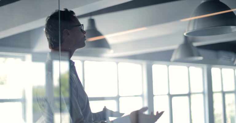 Man asking question to audience in workplace representing 10 background check terms you need to know