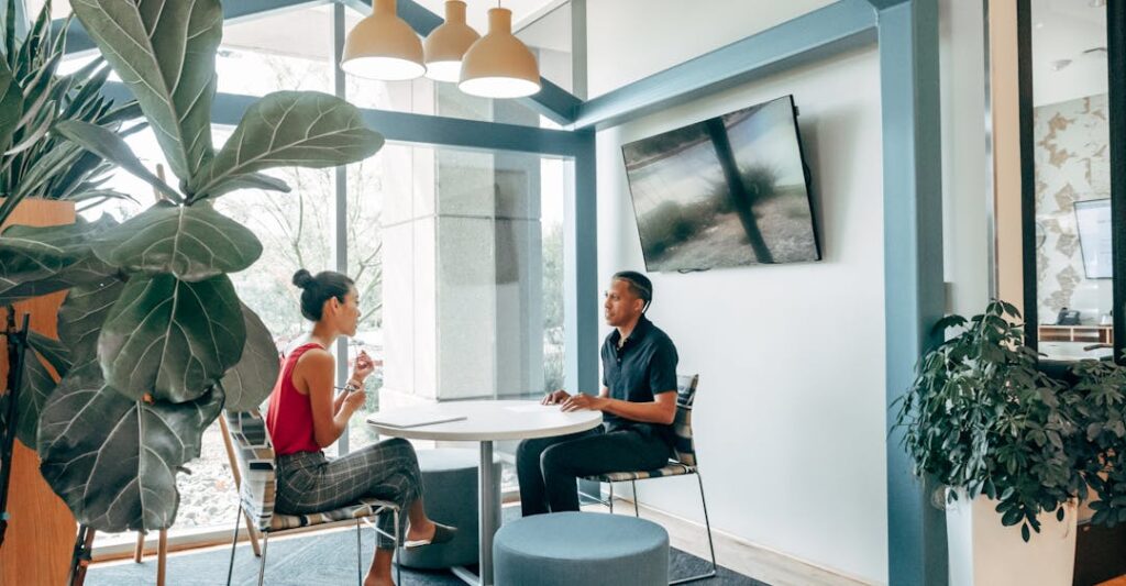 Candidate meeting with employer in job interview at office around round table using tips for addressing a criminal record in an interview