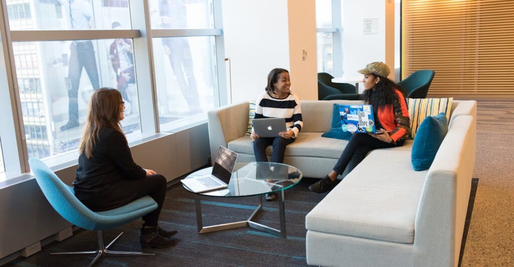 Employees on laptops in an office in a safe and relaxed setting thanks to employment background checks and employee screening