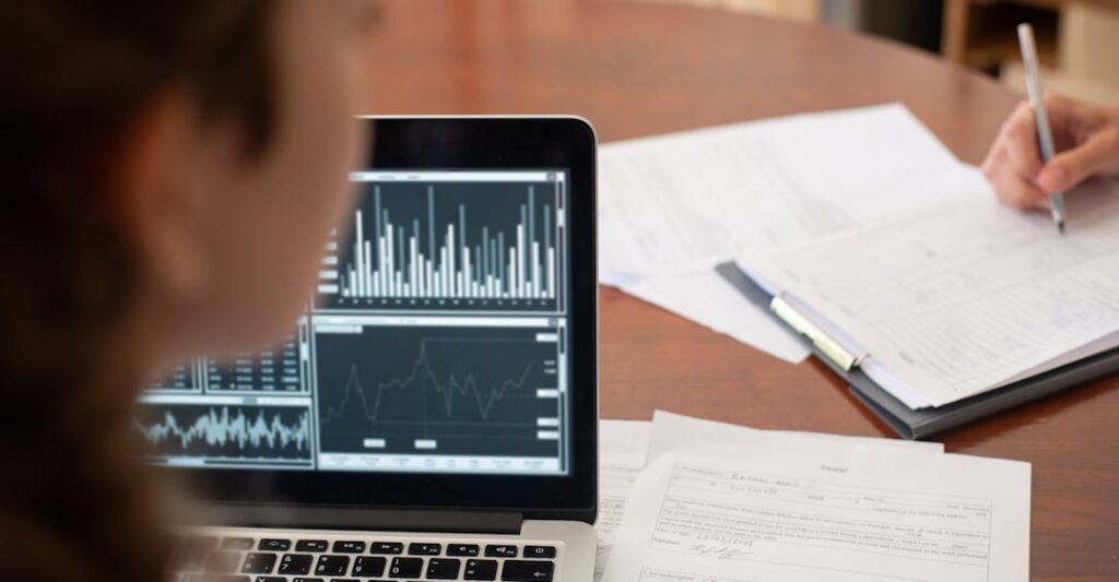 Financial services employee with PEP check working at laptop