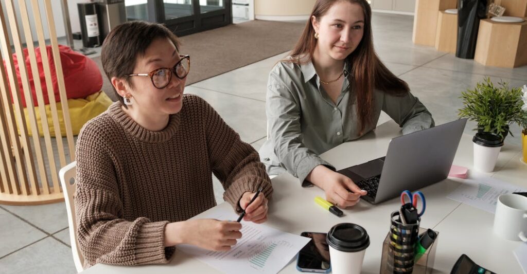 Collaborative employees at desk discussing why background checks are important