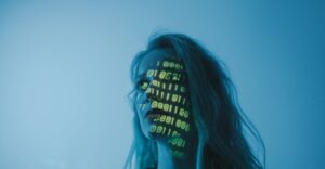 Woman's face with computer code overlay representing the future of biometrics, blockchain technology, and verifiable credentials