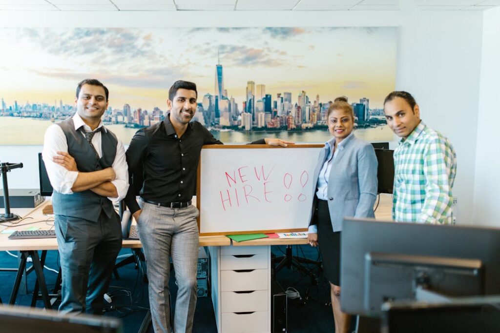 Colleagues celebrating new hire at workplace after pre-employment background checks