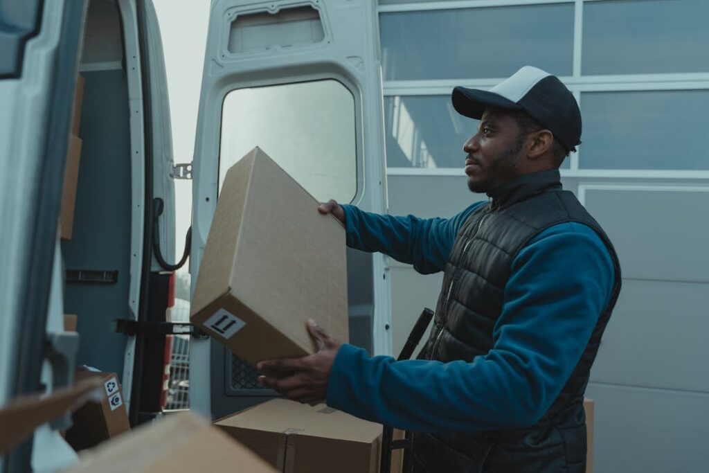 UK delivery driver gig worker packing up parcels vetted with new Right to Work checks