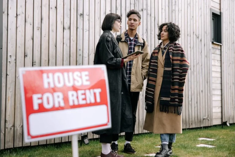 Young-professional-couple-reviewing-rental-agreement-with-landlord-after-background-checks